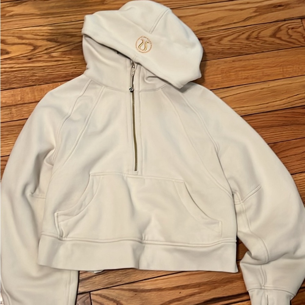 Lululemon crop hoodie cream color with gold zipper and brand